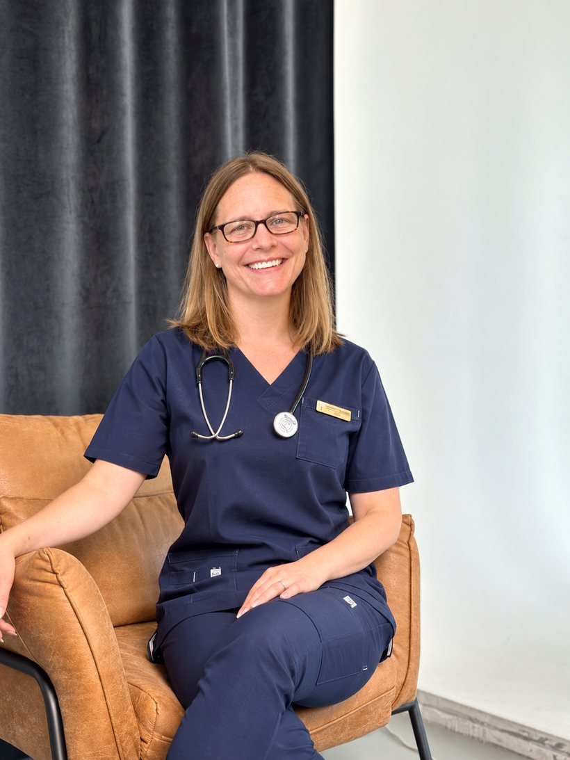 Dr. Shannon Scott-Vernaglia seated with her stethoscope